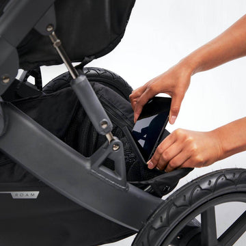 Mesh pockets on the Roam Stroller storing a phone